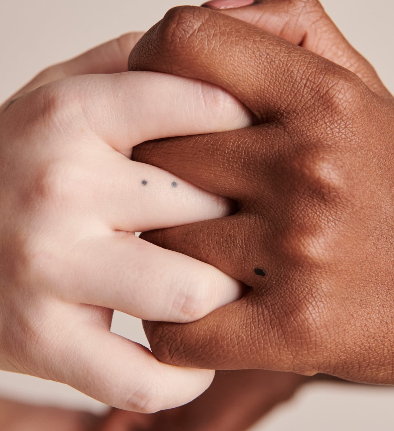 Photo of hands with interlocking fingers