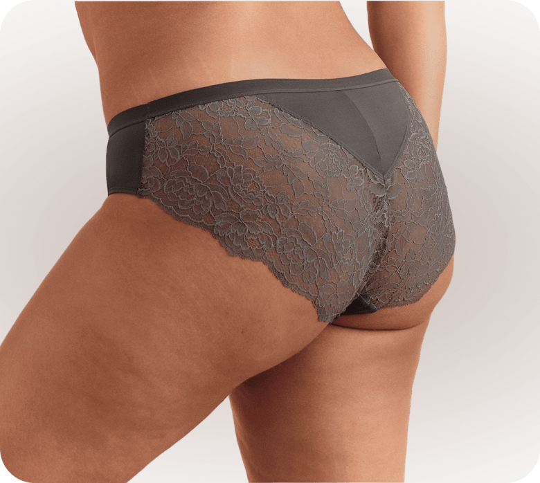 A woman's lower body, wearing grey lace-trimmed underwear, is shown against a plain white background.