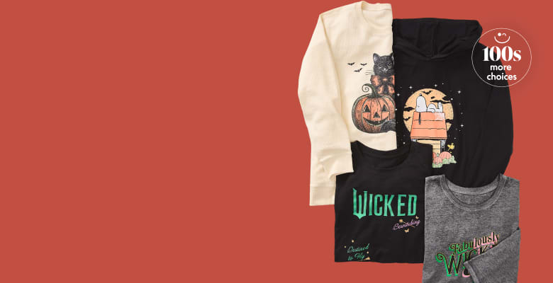 Four Halloween-themed t-shirts are neatly stacked on a plain red background with a circular '100s more choices' graphic in the upper right corner.