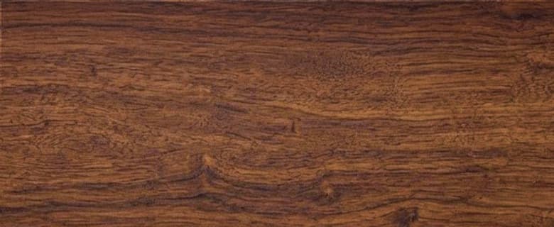 A close-up view of dark brown wood grain fills the frame, with subtle variations in color and texture creating a natural, organic background.