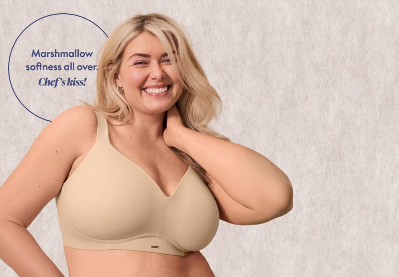 A smiling blonde woman wearing a beige bra stands in the foreground against a textured light-grey background with a blue circular text overlay.