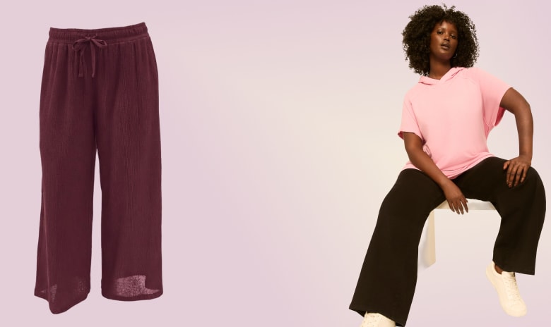 A pair of maroon wide-leg pants is on the left and a woman wearing a pink t-shirt and black pants is on the right, all set against a light purple background.