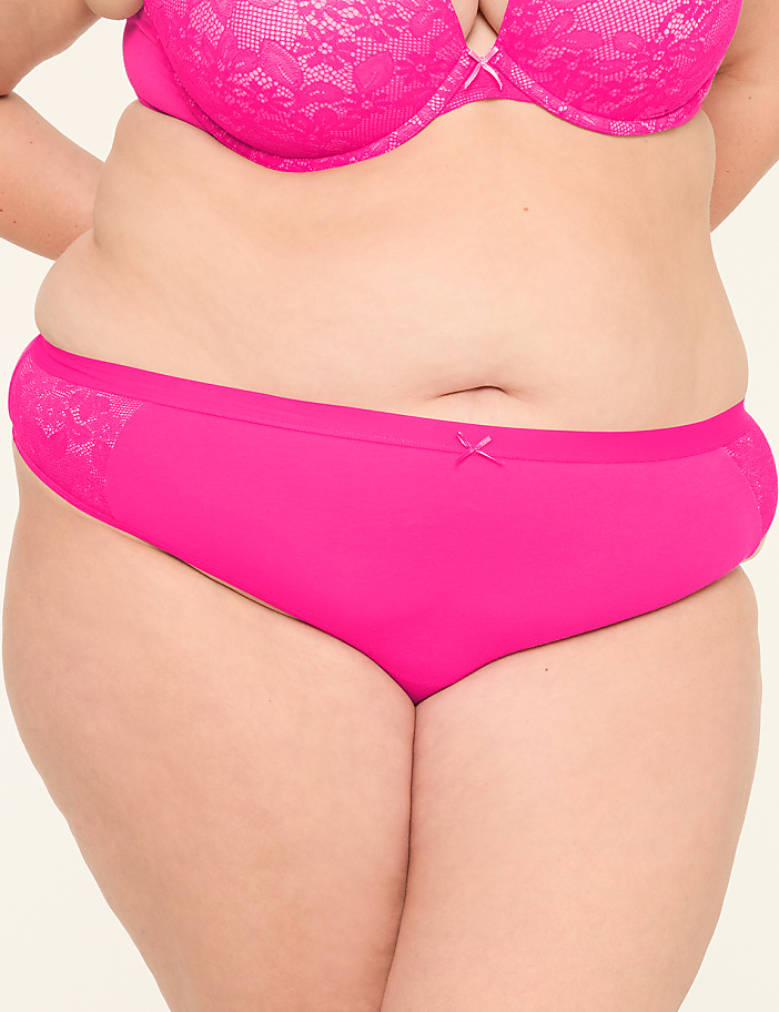 A close-up of a woman's torso in bright pink lace bra and matching bikini-style underwear against a plain background.