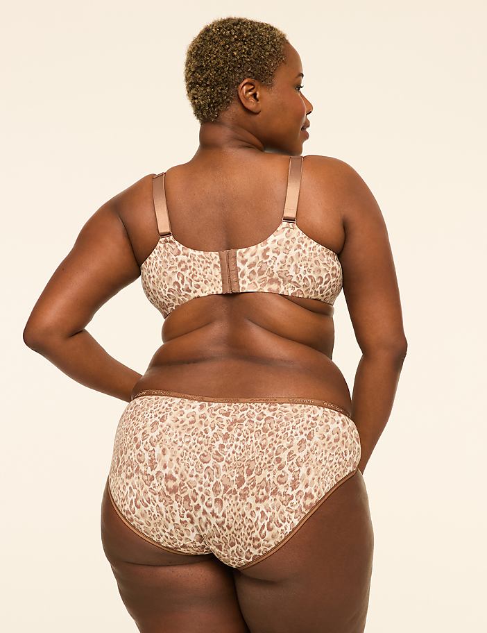 A woman with short, blonde hair is shown from behind, wearing a leopard-print bra and underwear against a plain, light-colored background.