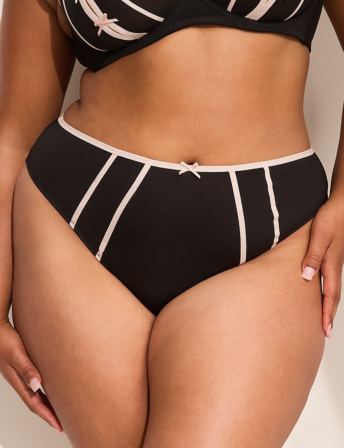 A woman's torso is shown in the foreground, wearing black and pink lingerie, against a plain white background.