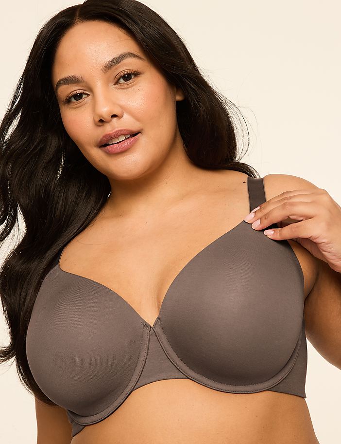 A woman with dark hair and a gray bra is in the foreground, with a plain, light-colored background.