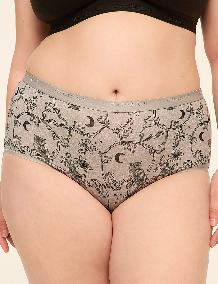 A person wears grey underwear with a pattern of owls and moons, against a plain background.
