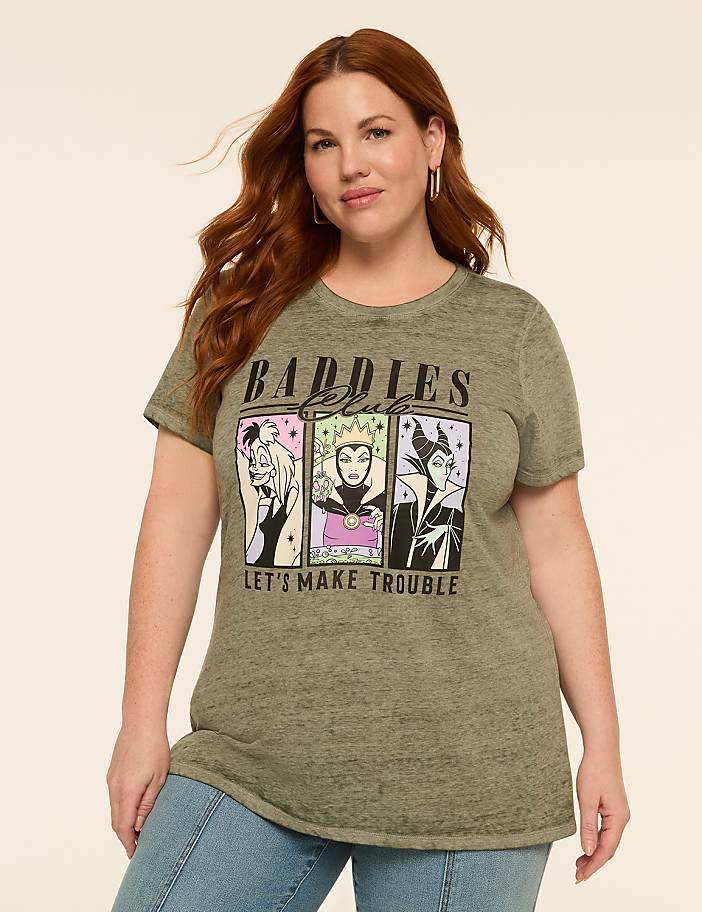 A woman in a green t-shirt with Disney villains on it stands against a plain, light-colored background.