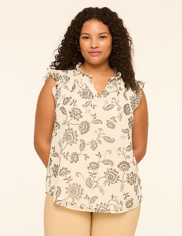 A woman with curly dark hair stands in the foreground against a plain, light-colored background.