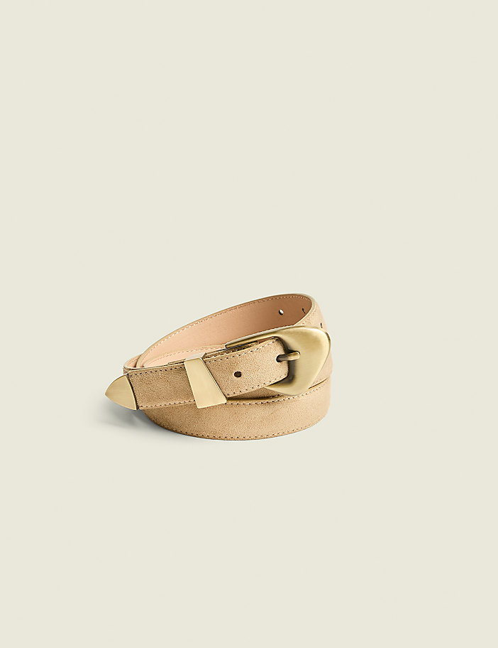 A tan suede belt with a brass buckle is laid out against a plain, light beige background.