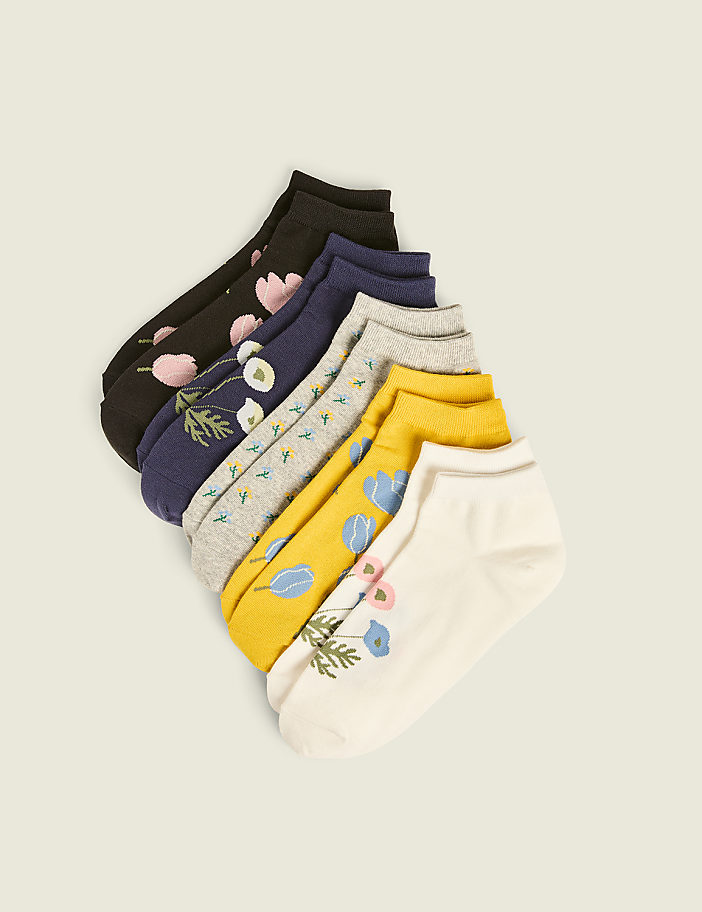 A fan of colorful, patterned ankle socks with floral designs is arranged diagonally against a plain, light background.