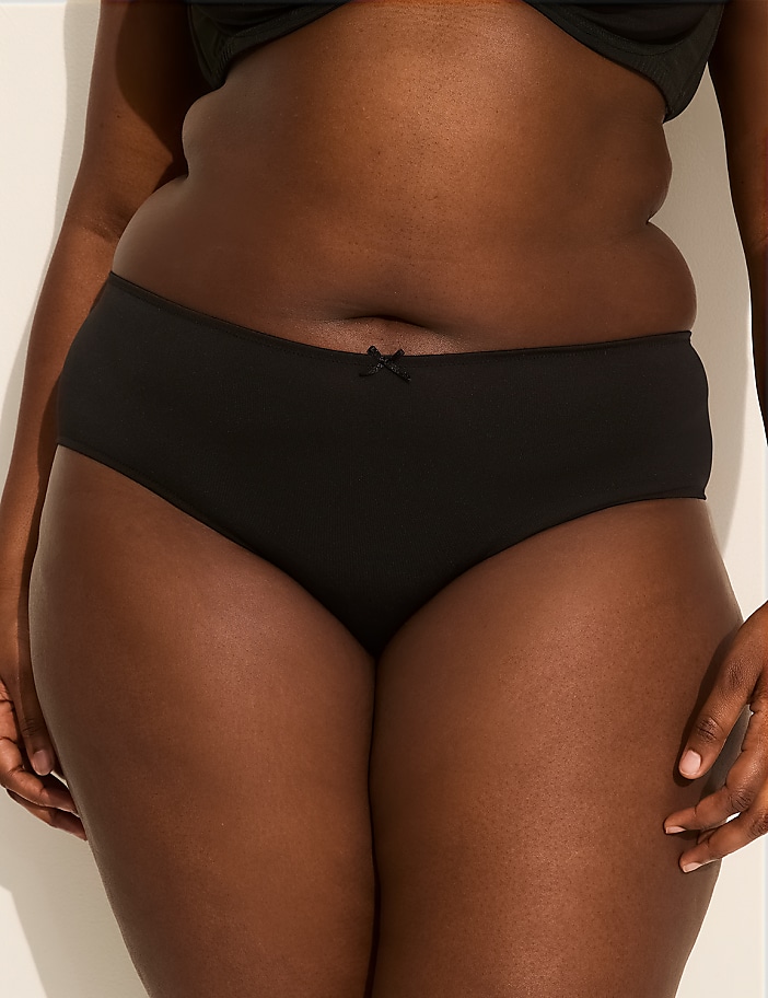 A person's torso is shown from the waist down, wearing black underwear, against a plain white background.