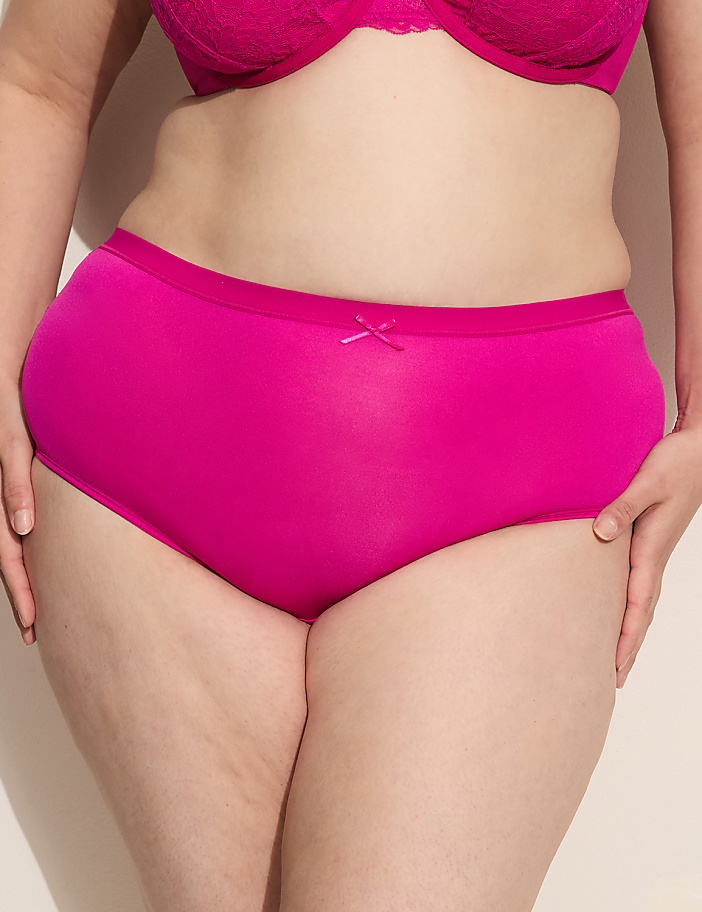 A person's torso is shown from the waist down, wearing bright pink underwear and bra against a plain background.