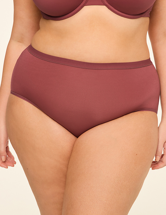 A close-up of a person's torso in a mauve bra and matching high-waisted underwear is set against a plain, light background.