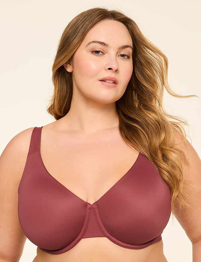 A woman with blonde hair and a mauve bra is shown against a plain, light-colored background.