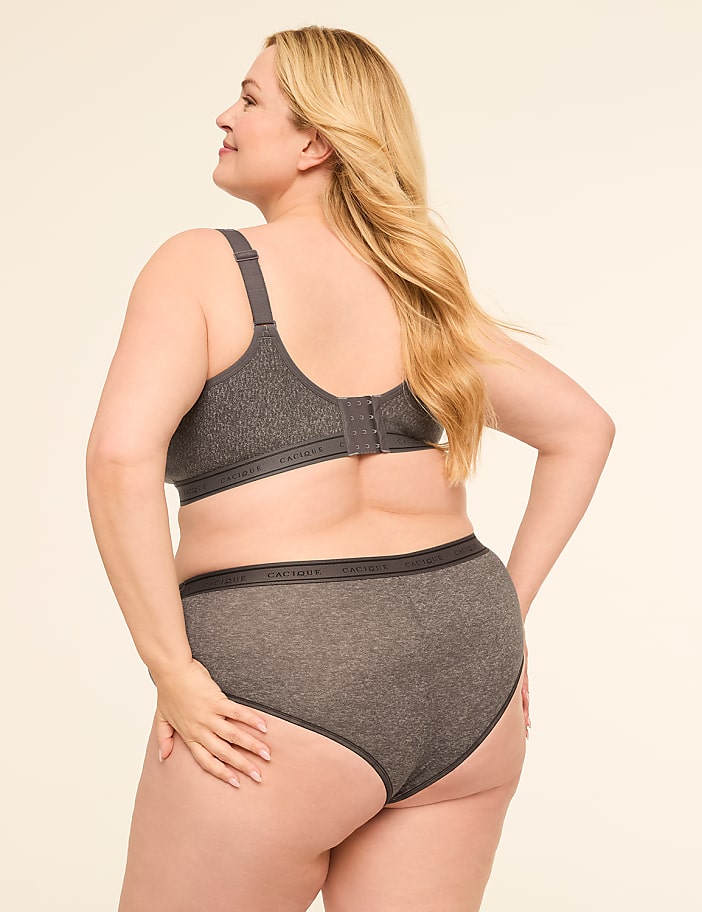 A woman in a grey bra and underwear stands against a plain, light background.
