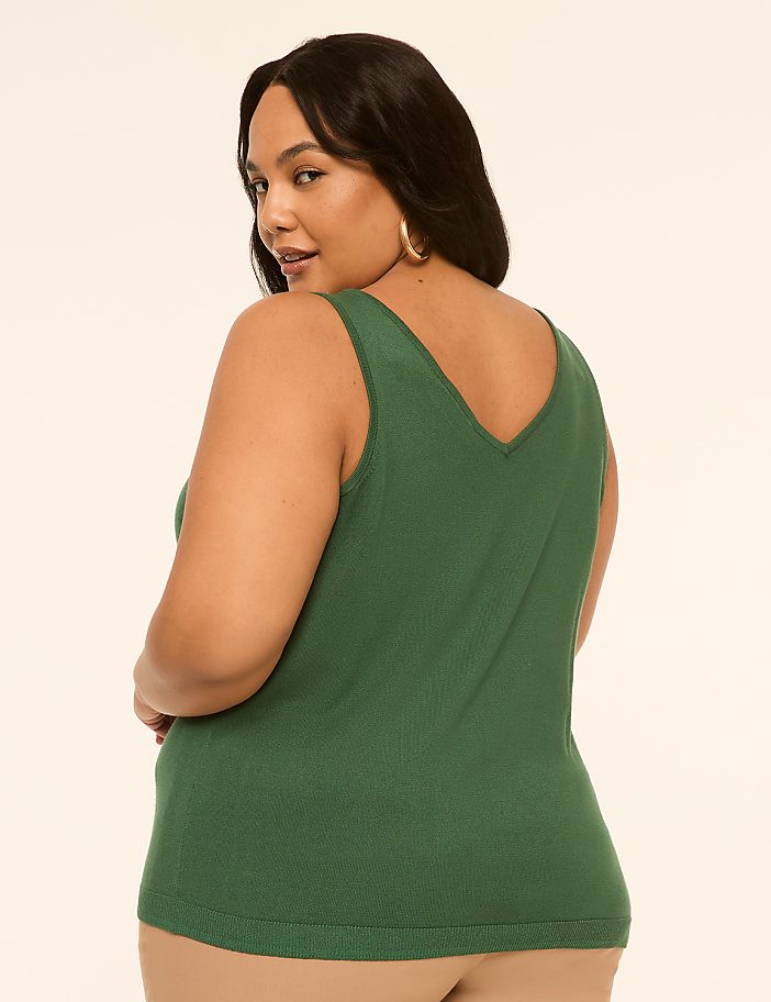 A woman in a green tank top is shown from the back, looking over her shoulder, against a plain, light-colored background.