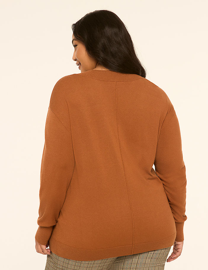 A woman in a brown sweater is shown from the back, with a plain, light-colored background.
