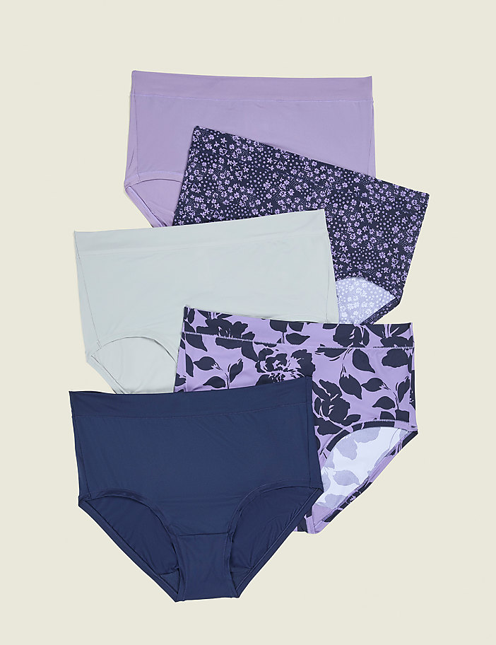 Five pairs of women's underwear, some solid colored and some with floral patterns, are neatly stacked on a light beige background.