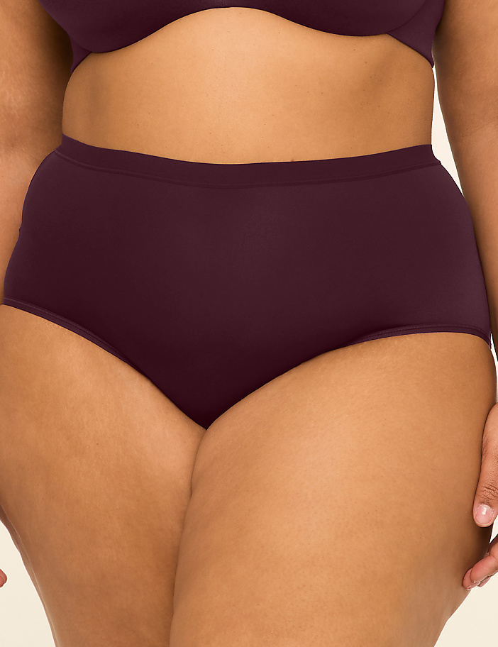 A person's torso is shown from the waist down, wearing plum-colored high-waisted underwear and a matching bra, against a plain background.