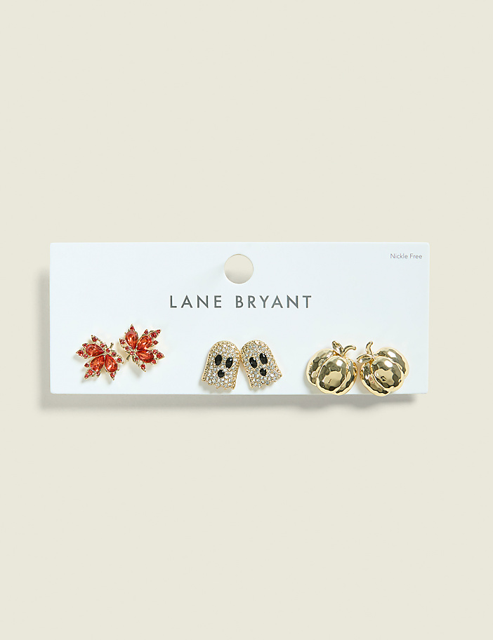 Three pairs of Halloween-themed earrings, including a red leaf, two ghosts, and two pumpkins, are displayed on a white card against a pale beige background.