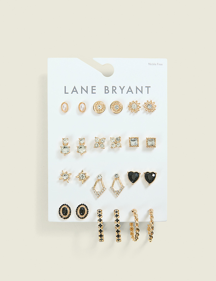 A white card displays an assortment of gold and black earrings in various shapes and sizes, set against a plain, light brown background.