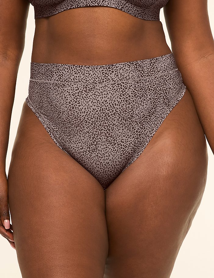 A person's lower body is shown wearing high-waisted leopard print underwear against a plain background.