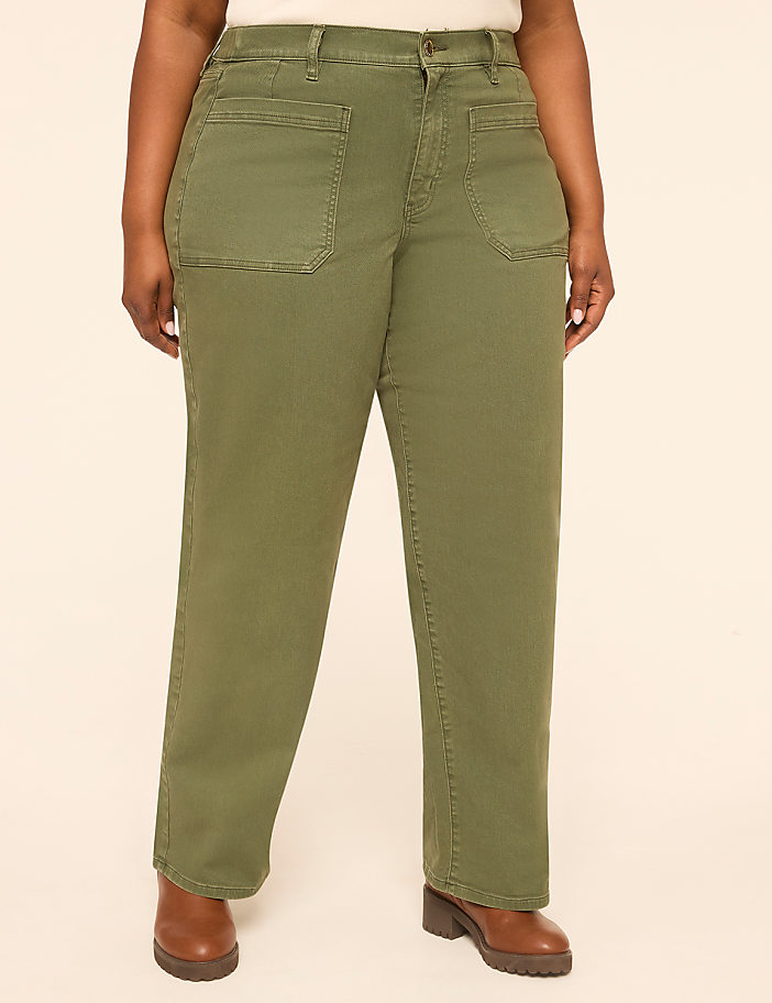 A person wearing olive green utility pants stands against a plain, light-colored background.