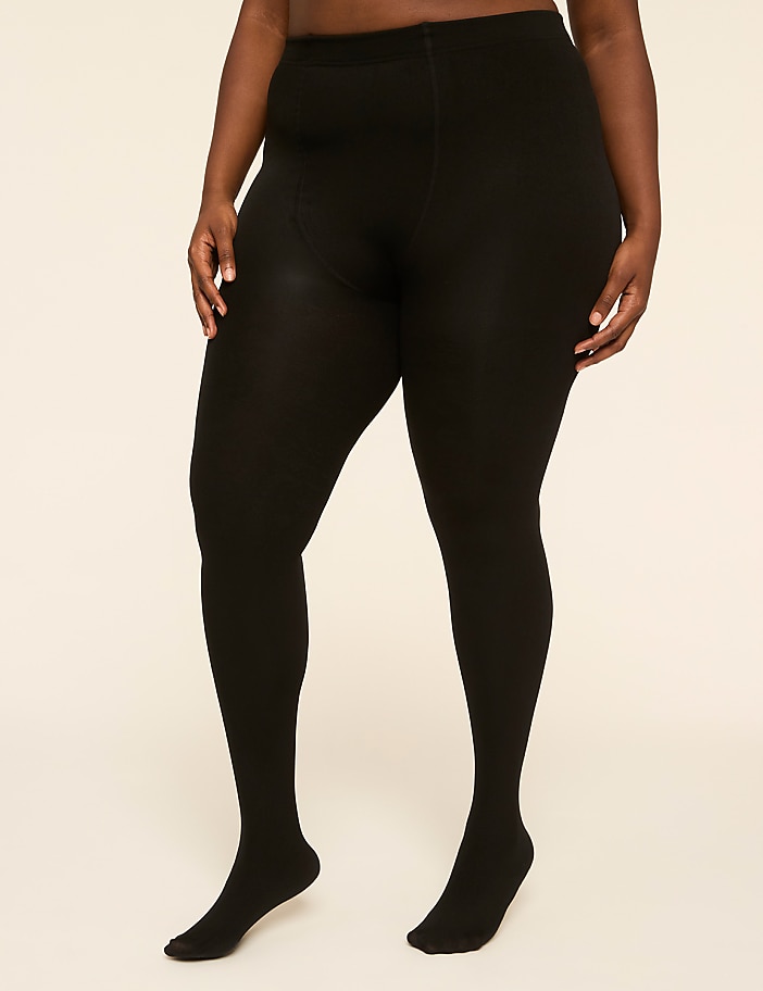 A person's legs are covered in black tights in the foreground, against a plain, light-colored background.