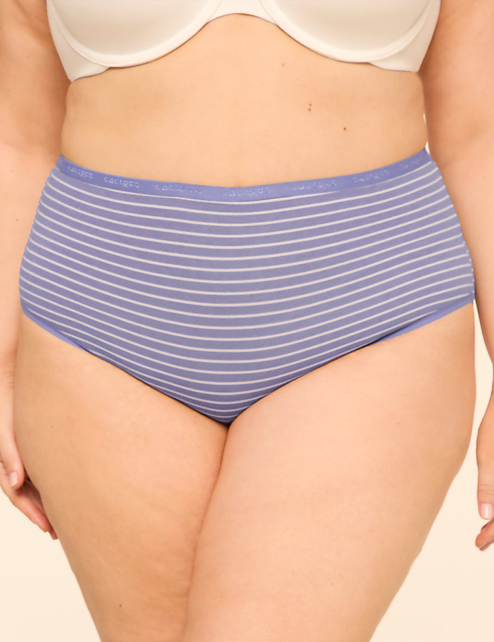 A person wearing striped underwear stands against a plain background.