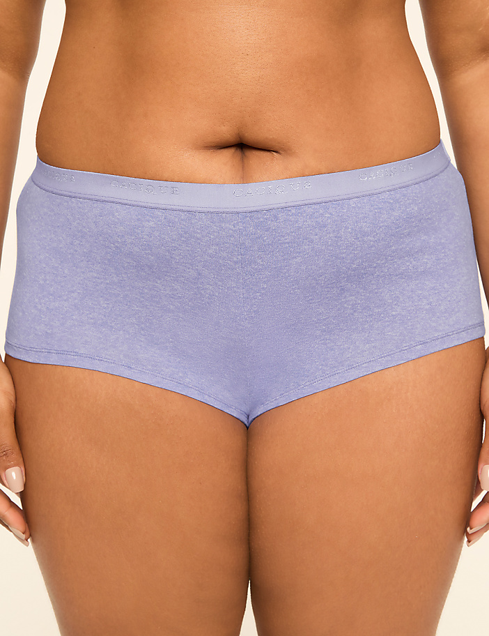 A close-up of a person's torso wearing light purple boy shorts, with a plain, light-colored background.