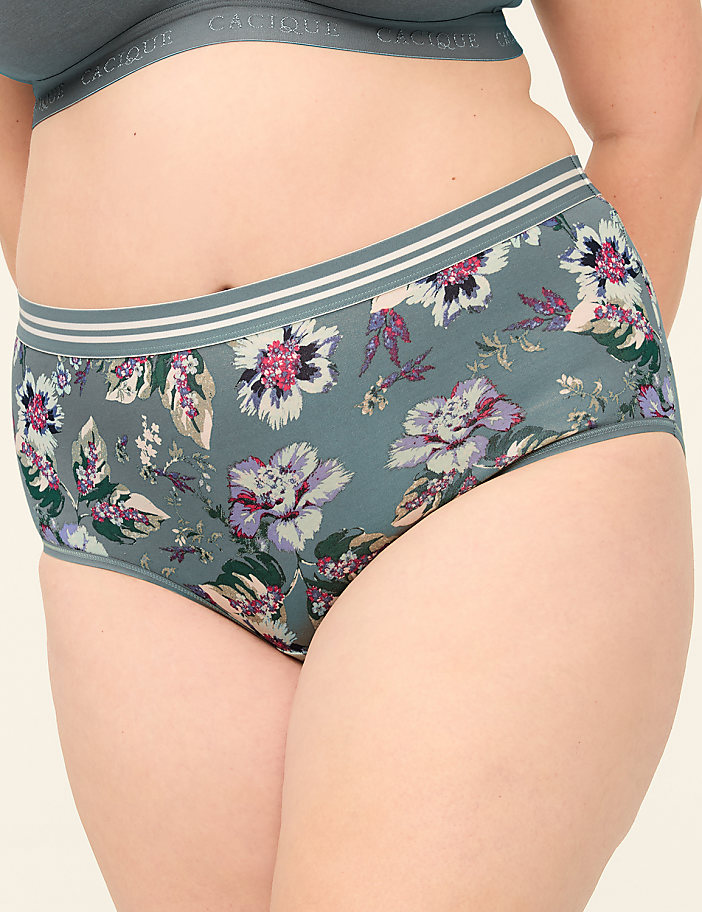 A close-up of a person wearing floral-patterned underwear with a plain background.