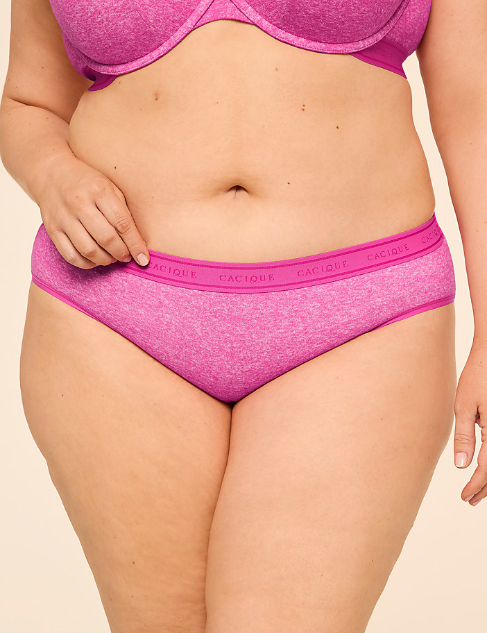 A person's torso is shown from the waist up, wearing pink underwear and bra against a plain background.