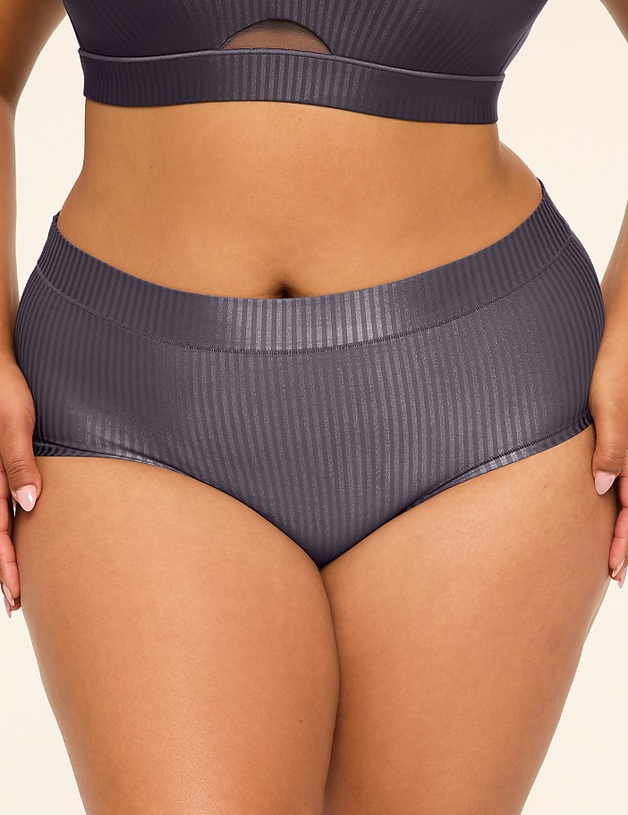 A person in ribbed grey underwear is shown against a plain white background.