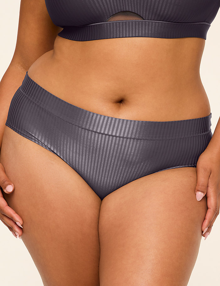 A person in dark grey ribbed underwear and a matching bra is shown against a plain, light background.