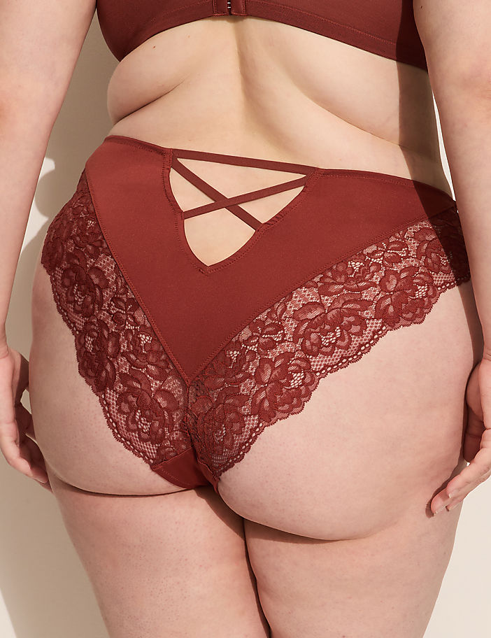 A person's lower back and buttocks are shown from behind, wearing maroon lace-trimmed underwear, against a plain, light-colored background.
