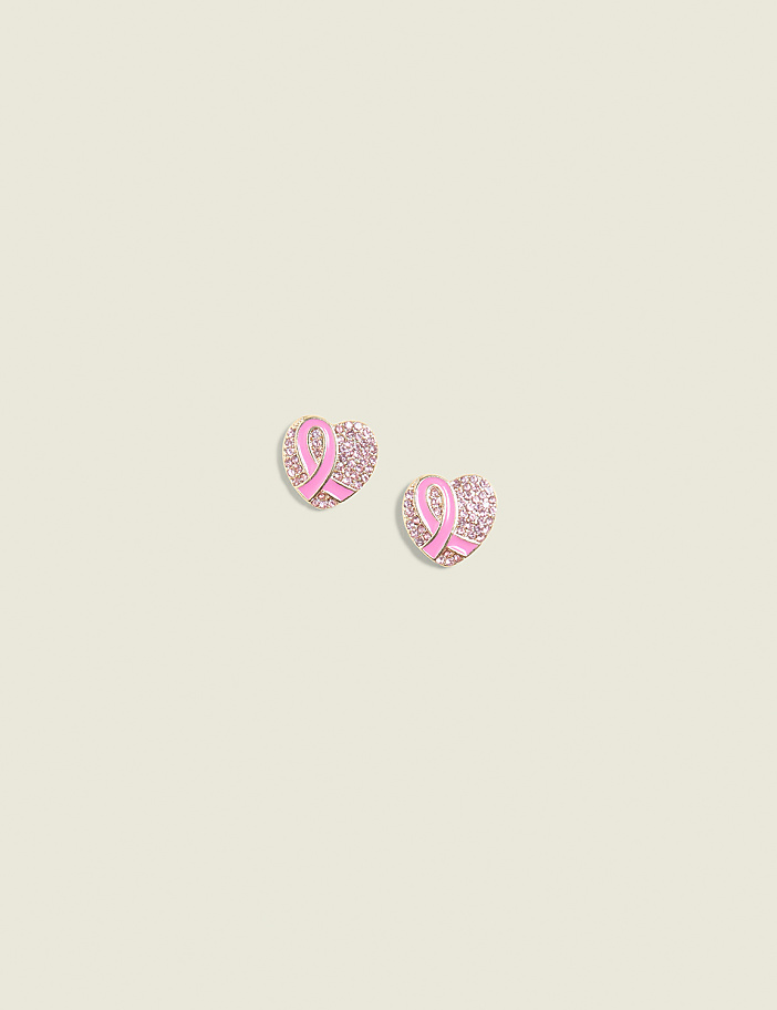 Two heart-shaped earrings with pink ribbons and rhinestones are centered on a pale yellow background.