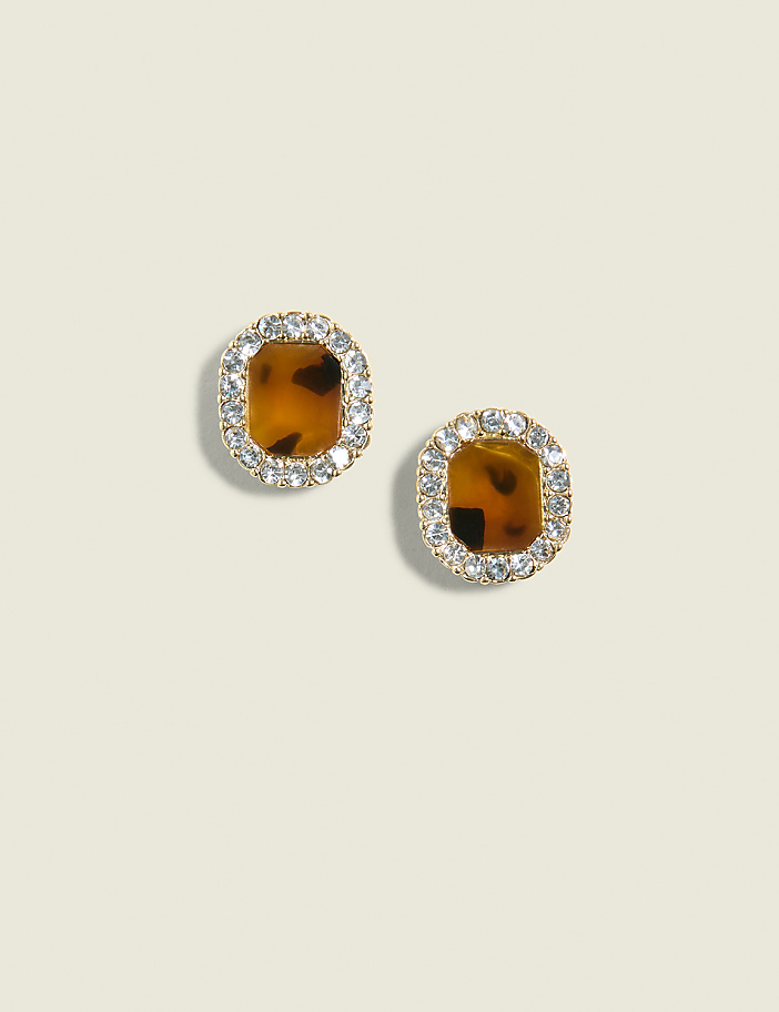 A pair of square tortoise shell earrings with a halo of clear rhinestones are centered against a plain, light beige background.