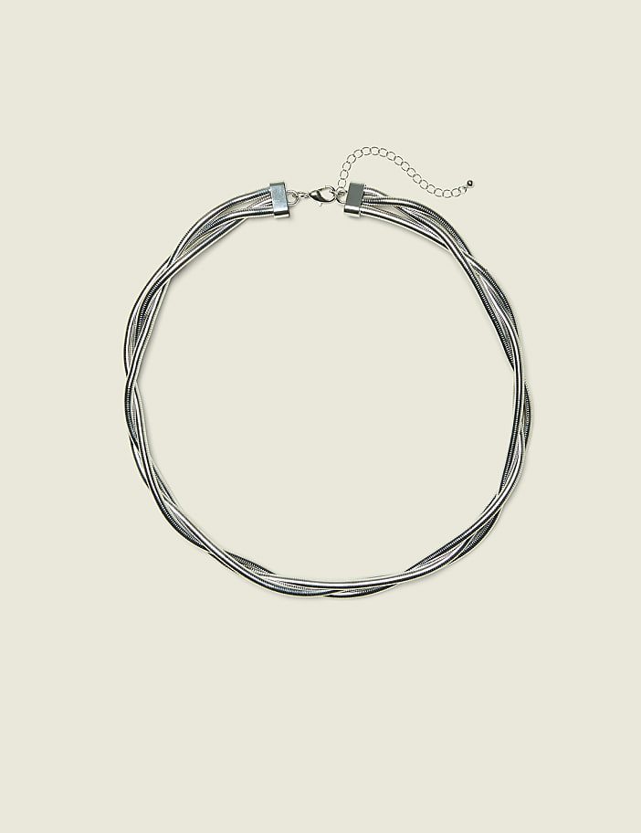 A silver multi-strand twisted necklace with a clasp and extension chain rests on a pale yellow background.