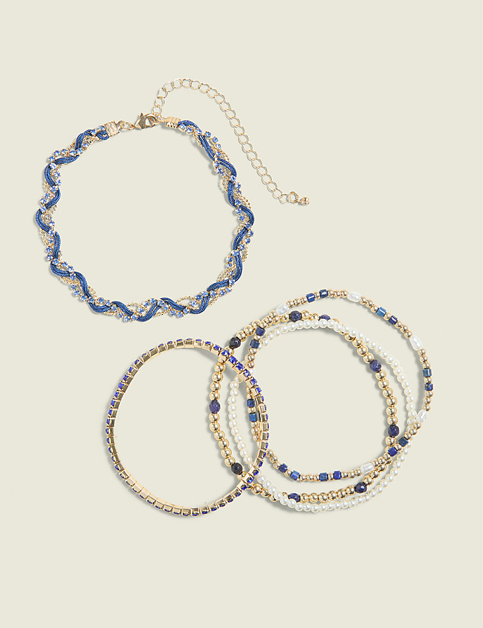 A blue and gold twisted necklace rests above a cluster of beaded bracelets on a plain white background.