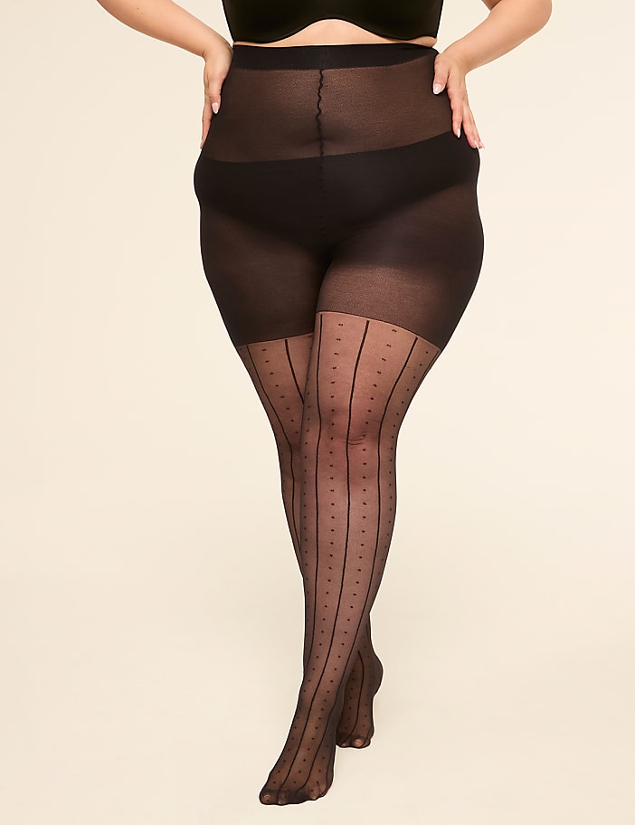 A person stands in sheer black tights with a polka dot and stripe pattern against a plain, light-colored background.