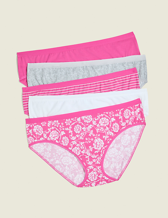 Five pairs of women's underwear, with the bottom pair featuring a pink floral pattern, are neatly stacked against a plain, light beige background.