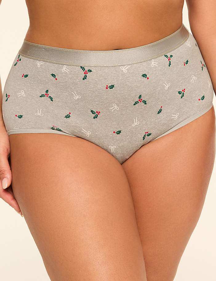 A person's lower body is shown wearing grey underwear with a holly and bow pattern, against a plain, light-colored background.