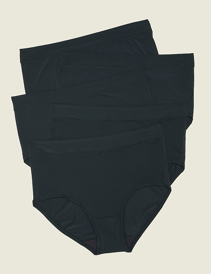 Three dark grey briefs are stacked in the foreground against a plain, light beige background.