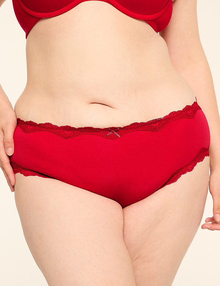 A person's torso is shown from the waist down, wearing red lace-trimmed underwear and a red bra, against a plain white background.