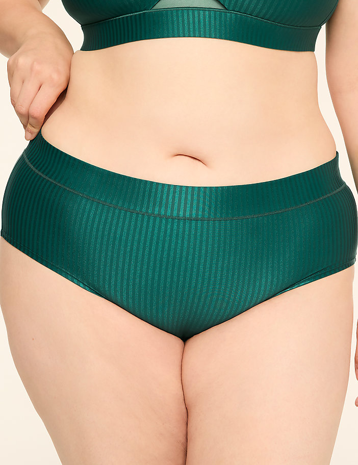 A person wearing green ribbed underwear is shown against a plain background.