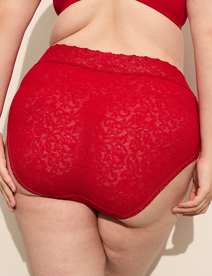 A person's lower back and buttocks are shown from behind, wearing red lace underwear and a matching bra, against a plain, light-colored background.