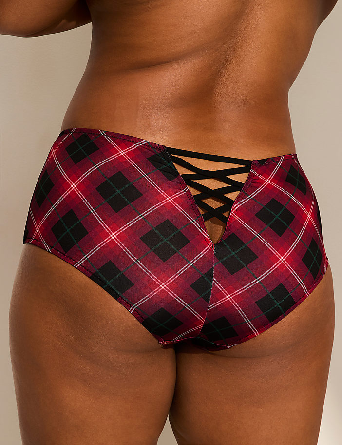 A person wearing red plaid underwear with a criss-cross detail on the back is shown against a plain, light-colored background.