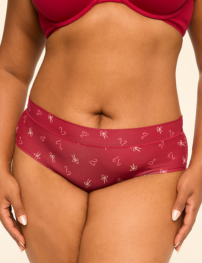 A person in maroon underwear with a candy cane pattern is shown against a plain background.