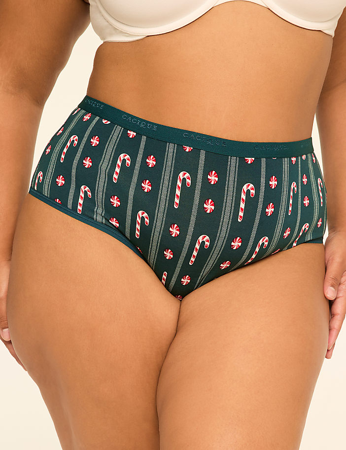 A person wearing green holiday-themed underwear with candy cane and peppermint patterns is shown against a plain background.